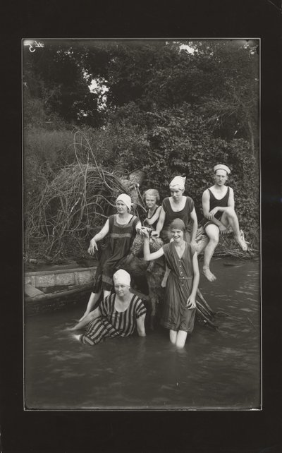 Group of One Man and Four Women in Swimming Suits Seated on a River Bank by Oscar C. Kuehn